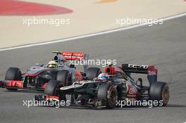 Romain Grosjean (FRA) Lotus F1 E21 and Sergio Perez (MEX) McLaren MP4-28 battle for position. 21.04.2013. Formula 1 World Championship, Rd 4, Bahrain Grand Prix, Sakhir, Bahrain, Race Day