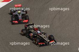 Romain Grosjean (FRA) Lotus F1 E21 leads Sergio Perez (MEX) McLaren MP4-28. 21.04.2013. Formula 1 World Championship, Rd 4, Bahrain Grand Prix, Sakhir, Bahrain, Race Day