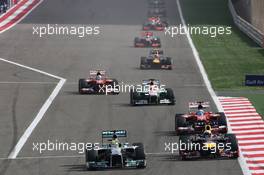 Nico Rosberg (GER) Mercedes AMG F1 W04 and Sebastian Vettel (GER) Red Bull Racing RB9 battle for the lead of the race. 21.04.2013. Formula 1 World Championship, Rd 4, Bahrain Grand Prix, Sakhir, Bahrain, Race Day
