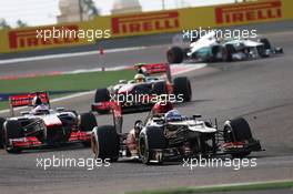 Romain Grosjean (FRA) Lotus F1 E21 leads team mate Jenson Button (GBR) McLaren MP4-28 and Sergio Perez (MEX) McLaren MP4-28. 21.04.2013. Formula 1 World Championship, Rd 4, Bahrain Grand Prix, Sakhir, Bahrain, Race Day