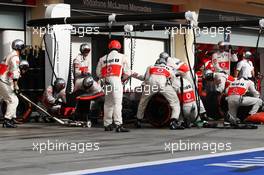 Jenson Button (GBR) McLaren MP4-28 makes a pit stop. 21.04.2013. Formula 1 World Championship, Rd 4, Bahrain Grand Prix, Sakhir, Bahrain, Race Day