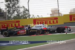 Sergio Perez (MEX) McLaren MP4-28 and Romain Grosjean (FRA) Lotus F1 E21 battle for position. 21.04.2013. Formula 1 World Championship, Rd 4, Bahrain Grand Prix, Sakhir, Bahrain, Race Day