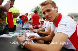 Max Chilton (GBR) Marussia F1 Team and team mate Jules Bianchi (FRA) Marussia F1 Team sign autographs for the fans. 20.04.2013. Formula 1 World Championship, Rd 4, Bahrain Grand Prix, Sakhir, Bahrain, Qualifying Day