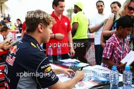 Sebastian Vettel (GER) Red Bull Racing signs autographs for the fans. 20.04.2013. Formula 1 World Championship, Rd 4, Bahrain Grand Prix, Sakhir, Bahrain, Qualifying Day