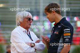 (L to R): Bernie Ecclestone (GBR) CEO Formula One Group (FOM) talks with Sebastian Vettel (GER) Red Bull Racing. 20.04.2013. Formula 1 World Championship, Rd 4, Bahrain Grand Prix, Sakhir, Bahrain, Qualifying Day