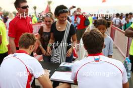 (L to R): Max Chilton (GBR) Marussia F1 Team and team mate Jules Bianchi (FRA) Marussia F1 Team sign autographs for the fans. 20.04.2013. Formula 1 World Championship, Rd 4, Bahrain Grand Prix, Sakhir, Bahrain, Qualifying Day