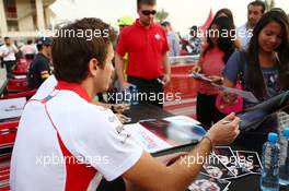 Jules Bianchi (FRA) Marussia F1 Team signs autographs for the fans. 20.04.2013. Formula 1 World Championship, Rd 4, Bahrain Grand Prix, Sakhir, Bahrain, Qualifying Day