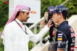 (L to R): Sebastian Vettel (GER) Red Bull Racing with Salman Bin Isa Al Khalifa (BRN) Acting Chief Executive Officer Bahrain International Circruit. 18.04.2013. Formula 1 World Championship, Rd 4, Bahrain Grand Prix, Sakhir, Bahrain, Preparation Day