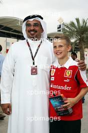 HRH Prince Salman bin Hamad Al Khalifa, Crown Prince of Bahrain with a young Ferrari fan. 18.04.2013. Formula 1 World Championship, Rd 4, Bahrain Grand Prix, Sakhir, Bahrain, Preparation Day