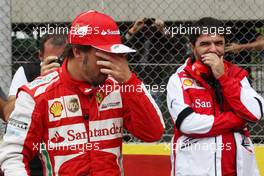 Fernando Alonso (ESP) Ferrari on the grid with Luis Garcia Abad (ESP) Driver Manager. 24.11.2013. Formula 1 World Championship, Rd 19, Brazilian Grand Prix, Sao Paulo, Brazil, Race Day.