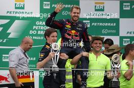 Race winner Sebastian Vettel (GER) Red Bull Racing celebrates with the team. 24.11.2013. Formula 1 World Championship, Rd 19, Brazilian Grand Prix, Sao Paulo, Brazil, Race Day.