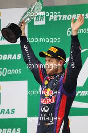 Race winner Sebastian Vettel (GER) Red Bull Racing celebrates on the podium. 24.11.2013. Formula 1 World Championship, Rd 19, Brazilian Grand Prix, Sao Paulo, Brazil, Race Day.