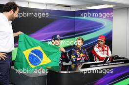 Mark Webber (AUS) Red Bull Racing, celebrating his final GP, holds a brazilian flag, signed by Bernie Ecclestone (GBR) CEO Formula One Group (FOM) and all the drivers, alongside Sebastian Vettel (GER) Red Bull Racing (Centre), Fernando Alonso (ESP) Ferrari, (Right) and Matteo Bonciani (ITA) FIA Media Delegate (Left). 24.11.2013. Formula 1 World Championship, Rd 19, Brazilian Grand Prix, Sao Paulo, Brazil, Race Day.