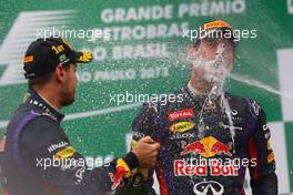 Race winner Sebastian Vettel (GER) Red Bull Racing celebrates on the podium with team mate Mark Webber (AUS) Red Bull Racing. 24.11.2013. Formula 1 World Championship, Rd 19, Brazilian Grand Prix, Sao Paulo, Brazil, Race Day.