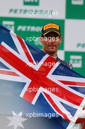 Mark Webber (AUS) Red Bull Racing celebrates his second position and last GP on the podium. 24.11.2013. Formula 1 World Championship, Rd 19, Brazilian Grand Prix, Sao Paulo, Brazil, Race Day.