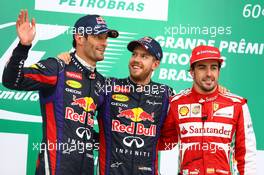 The podium (L to R): Mark Webber (AUS) Red Bull Racing, second; Sebastian Vettel (GER) Red Bull Racing, race winner; Fernando Alonso (ESP) Ferrari, third. 24.11.2013. Formula 1 World Championship, Rd 19, Brazilian Grand Prix, Sao Paulo, Brazil, Race Day.