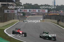 (L to R): Jules Bianchi (FRA) Marussia F1 Team MR02 and Charles Pic (FRA) Caterham CT03 battle for position. 24.11.2013. Formula 1 World Championship, Rd 19, Brazilian Grand Prix, Sao Paulo, Brazil, Race Day.