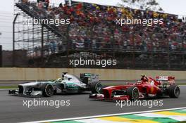 Nico Rosberg (GER) Mercedes AMG F1 W04 and Felipe Massa (BRA) Ferrari F138 battle for position. 24.11.2013. Formula 1 World Championship, Rd 19, Brazilian Grand Prix, Sao Paulo, Brazil, Race Day.