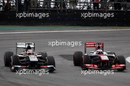 (L to R): Nico Hulkenberg (GER) Sauber C32 and Jenson Button (GBR) McLaren MP4-28 battle for position. 24.11.2013. Formula 1 World Championship, Rd 19, Brazilian Grand Prix, Sao Paulo, Brazil, Race Day.