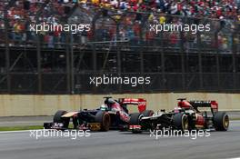 Jean-Eric Vergne (FRA) Scuderia Toro Rosso STR8 and Heikki Kovalainen (FIN) Lotus F1 E21 battle for position. 24.11.2013. Formula 1 World Championship, Rd 19, Brazilian Grand Prix, Sao Paulo, Brazil, Race Day.