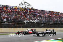 Sergio Perez (MEX) McLaren MP4-28 and Valtteri Bottas (FIN) Williams FW35 battle for position. 24.11.2013. Formula 1 World Championship, Rd 19, Brazilian Grand Prix, Sao Paulo, Brazil, Race Day.