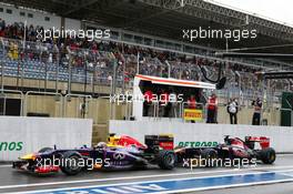 Sebastian Vettel (GER) Red Bull Racing RB9 leads Daniel Ricciardo (AUS) Scuderia Toro Rosso STR8 out of the pits. 23.11.2013. Formula 1 World Championship, Rd 19, Brazilian Grand Prix, Sao Paulo, Brazil, Qualifying Day.