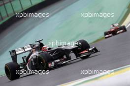Nico Hulkenberg (GER) Sauber C32 leads Fernando Alonso (ESP) Ferrari F138. 23.11.2013. Formula 1 World Championship, Rd 19, Brazilian Grand Prix, Sao Paulo, Brazil, Qualifying Day.