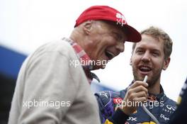 (L to R): Niki Lauda (AUT) Mercedes Non-Executive Chairman with Sebastian Vettel (GER) Red Bull Racing. 24.11.2013. Formula 1 World Championship, Rd 19, Brazilian Grand Prix, Sao Paulo, Brazil, Race Day.