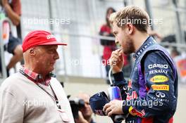 (L to R): Niki Lauda (AUT) Mercedes Non-Executive Chairman with Sebastian Vettel (GER) Red Bull Racing. 24.11.2013. Formula 1 World Championship, Rd 19, Brazilian Grand Prix, Sao Paulo, Brazil, Race Day.