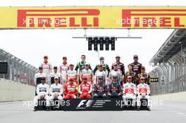 The drivers end of season group photograph (From back row (L to R)): Jules Bianchi (FRA) Marussia F1 Team; Max Chilton (GBR) Marussia F1 Team; Giedo van der Garde (NLD) Caterham F1 Team; Charles Pic (FRA) Caterham; Daniel Ricciardo (AUS) Scuderia Toro Rosso; Jean-Eric Vergne (FRA) Scuderia Toro Rosso; Valtteri Bottas (FIN) Williams; Pastor Maldonado (VEN) Williams; Adrian Sutil (GER) Sahara Force India F1; Paul di Resta (GBR) Sahara Force India F1; Esteban Gutierrez (MEX) Sauber; Nico Hulkenberg (GER) Sauber; Romain Grosjean (FRA) Lotus F1 Team; Heikki Kovalainen (FIN) Lotus F1 Team; Lewis Hamilton (GBR) Mercedes AMG F1; Nico Rosberg (GER) Mercedes AMG F1; Felipe Massa (BRA) Ferrari; Fernando Alonso (ESP) Ferrari; Sebastian Vettel (GER) Red Bull Racing; Mark Webber (AUS) Red Bull Racing; Jenson Button (GBR) McLaren; Sergio Perez (MEX) McLaren. 24.11.2013. Formula 1 World Championship, Rd 19, Brazilian Grand Prix, Sao Paulo, Brazil, Race Day.