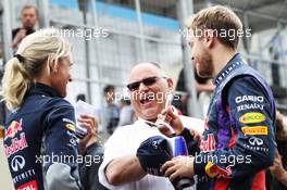 (L to R): Britta Roeske (AUT) Red Bull Racing Press Officer with Pat Behar (FRA) FIA, and Sebastian Vettel (GER) Red Bull Racing. 24.11.2013. Formula 1 World Championship, Rd 19, Brazilian Grand Prix, Sao Paulo, Brazil, Race Day.