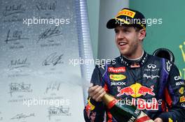 Race winner Sebastian Vettel (GER) Red Bull Racing celebrates with the champagne on the podium. 09.06.2013. Formula 1 World Championship, Rd 7, Canadian Grand Prix, Montreal, Canada, Race Day.