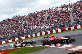 Max Chilton (GBR) Marussia F1 Team MR02 leads Romain Grosjean (FRA) Lotus F1 E21. 09.06.2013. Formula 1 World Championship, Rd 7, Canadian Grand Prix, Montreal, Canada, Race Day.