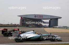 Lewis Hamilton (GBR) Mercedes AMG F1 W04 and Kimi Raikkonen (FIN) Lotus F1 E21. 12.04.2013. Formula 1 World Championship, Rd 3, Chinese Grand Prix, Shanghai, China, Practice Day.