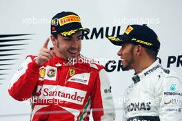 (L to R): Race winner Fernando Alonso (ESP) Ferrari on the podium with third placed Lewis Hamilton (GBR) Mercedes AMG F1. 14.04.2013. Formula 1 World Championship, Rd 3, Chinese Grand Prix, Shanghai, China, Race Day.