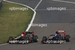 Romain Grosjean (FRA) Lotus F1 E21 and Daniel Ricciardo (AUS) Scuderia Toro Rosso STR8 battle for position. 14.04.2013. Formula 1 World Championship, Rd 3, Chinese Grand Prix, Shanghai, China, Race Day.