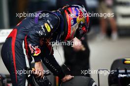 Sebastian Vettel (GER) Red Bull Racing RB9 checks the medium Pirelli tyre that he locked up on his final qualifying lap in parc ferme. 13.04.2013. Formula 1 World Championship, Rd 3, Chinese Grand Prix, Shanghai, China, Qualifying Day.