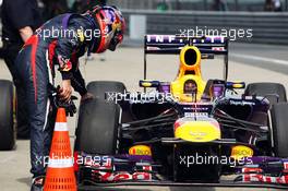 Sebastian Vettel (GER) Red Bull Racing RB9 checks the medium Pirelli tyre that he locked up on his final qualifying lap in parc ferme. 13.04.2013. Formula 1 World Championship, Rd 3, Chinese Grand Prix, Shanghai, China, Qualifying Day.
