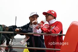 (L to R): Valtteri Bottas (FIN) Williams and Kimi Raikkonen (FIN) Ferrari on the drivers parade. 20.04.2014. Formula 1 World Championship, Rd 4, Chinese Grand Prix, Shanghai, China, Race Day.
