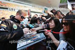 Kimi Raikkonen (FIN) Lotus F1 Team signs autographs for the fans. 11.04.2013. Formula 1 World Championship, Rd 3, Chinese Grand Prix, Shanghai, China, Preparation Day.