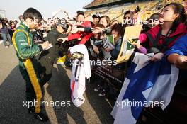 Ma Qing Hua (CHN) Caterham F1 Reserve Driver signs autographs for the fans. 11.04.2013. Formula 1 World Championship, Rd 3, Chinese Grand Prix, Shanghai, China, Preparation Day.