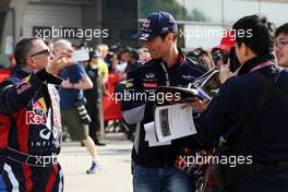 Mark Webber (AUS) Red Bull Racing signs autographs for the fans. 11.04.2013. Formula 1 World Championship, Rd 3, Chinese Grand Prix, Shanghai, China, Preparation Day.