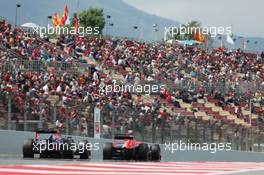 (L to R): Sebastian Vettel (GER) Red Bull Racing RB9 and Jules Bianchi (FRA) Marussia F1 Team MR02. 11.05.2013. Formula 1 World Championship, Rd 5, Spanish Grand Prix, Barcelona, Spain, Qualifying Day