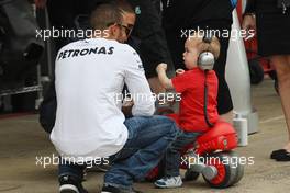 Lewis Hamilton (GBR) Mercedes AMG F1 with a young fan. 09.05.2013. Formula 1 World Championship, Rd 5, Spanish Grand Prix, Barcelona, Spain, Preparation Day