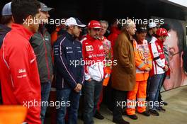 Drivers, marshals, and Jean Todt (FRA) FIA President pay their respects to Mark Robinson, the marshal tragically killed at the Canadian GP. 28.06.2013. Formula 1 World Championship, Rd 8, British Grand Prix, Silverstone, England, Practice Day.
