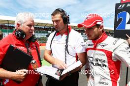 Pat Symonds (GBR) Marussia F1 Team Technical Consultant (Left) with Jules Bianchi (FRA) Marussia F1 Team on the grid. 30.06.2013. Formula 1 World Championship, Rd 8, British Grand Prix, Silverstone, England, Race Day.