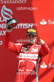 Fernando Alonso (ESP) Ferrari celebrates his third position on the podium. 30.06.2013. Formula 1 World Championship, Rd 8, British Grand Prix, Silverstone, England, Race Day.