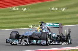 Lewis Hamilton (GBR) Mercedes AMG F1 W04 returns to the pits with a punctured rear Pirelli tyre. 30.06.2013. Formula 1 World Championship, Rd 8, British Grand Prix, Silverstone, England, Race Day.