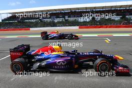 Sebastian Vettel (GER) Red Bull Racing car being passed by Mark Webber (AUS) Red Bull Racing. 30.06.2013. Formula 1 World Championship, Rd 8, British Grand Prix, Silverstone, England, Race Day.