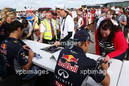 (L to R): Mark Webber (AUS) Red Bull Racing and team mate Sebastian Vettel (GER) Red Bull Racing sign autographs for the fans. 29.06.2013. Formula 1 World Championship, Rd 8, British Grand Prix, Silverstone, England, Qualifying Day.